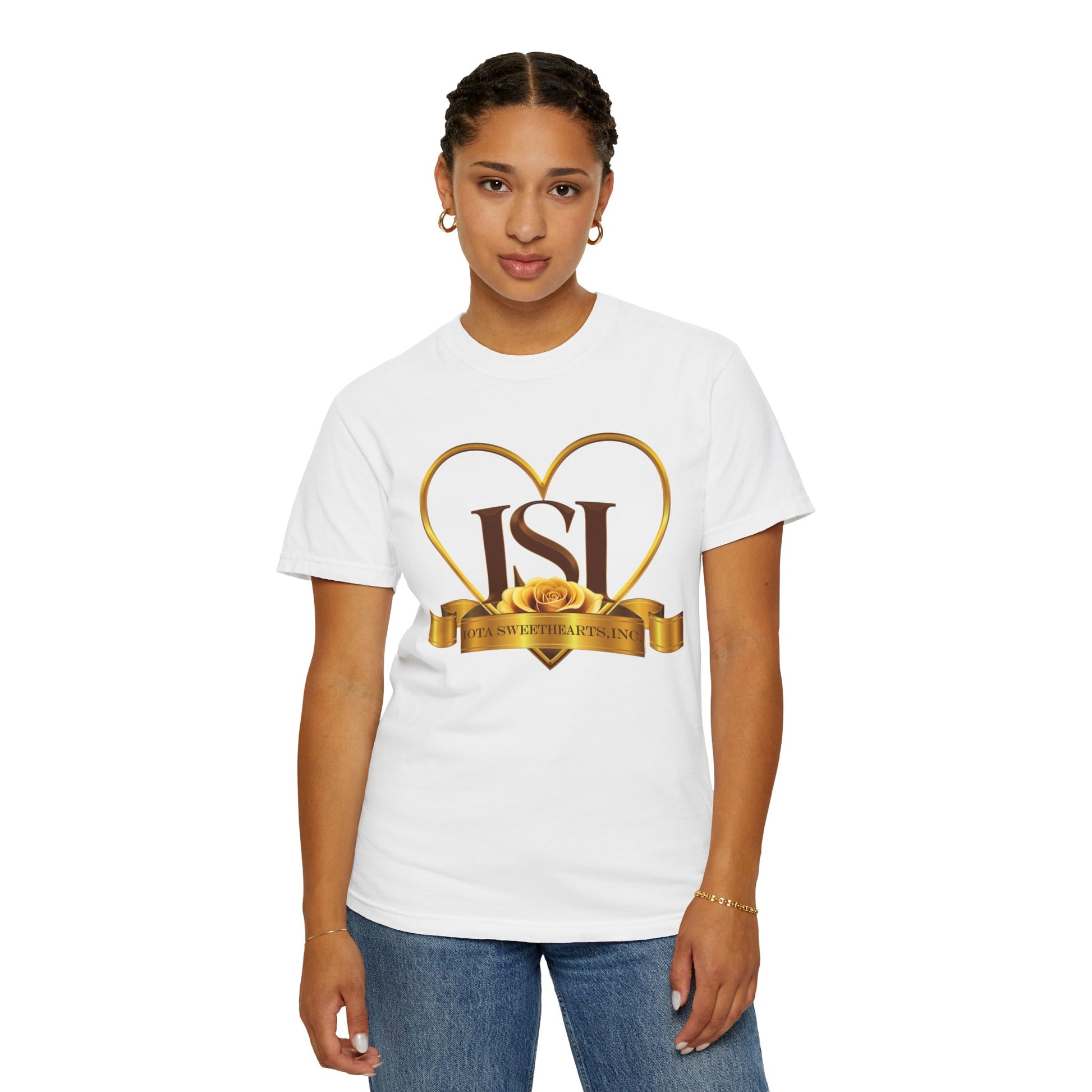 A confident young woman stands facing forward, wearing a white t-shirt with the Iota Sweethearts, Inc. logo prominently displayed on the front. The design features bold brown "ISI" letters framed by a gold heart outline, accented with a yellow rose and a gold ribbon that reads "Iota Sweethearts, Inc." She pairs the shirt with blue jeans and accessorizes with gold hoop earrings and a bracelet. The background is plain white, highlighting the clarity and detail of the logo.