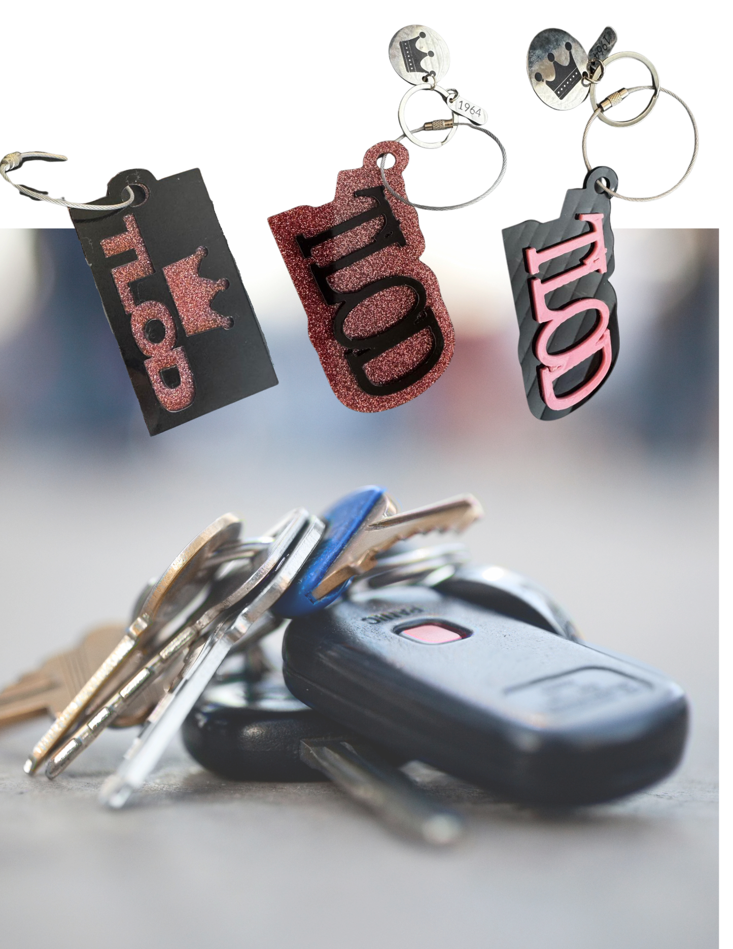 A collection of TLOD keychains in various styles, including black and pink acrylic designs with a crown charm and "1964" tag, floating above a blurred background of a set of keys with a car key fob. The keychains are positioned to showcase their unique glitter and engraved details.