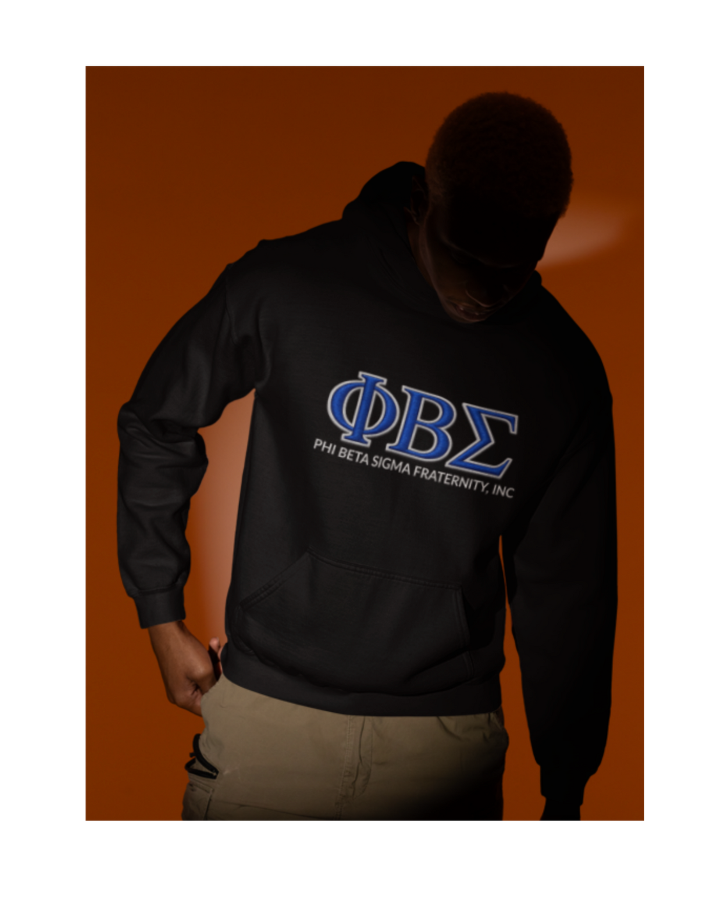 Model wearing black Phi Beta Sigma fraternity hoodie with blue ΦΒΣ Greek letters and Phi Beta Sigma Fraternity Inc text, Divine Nine Sigma fraternity apparel.