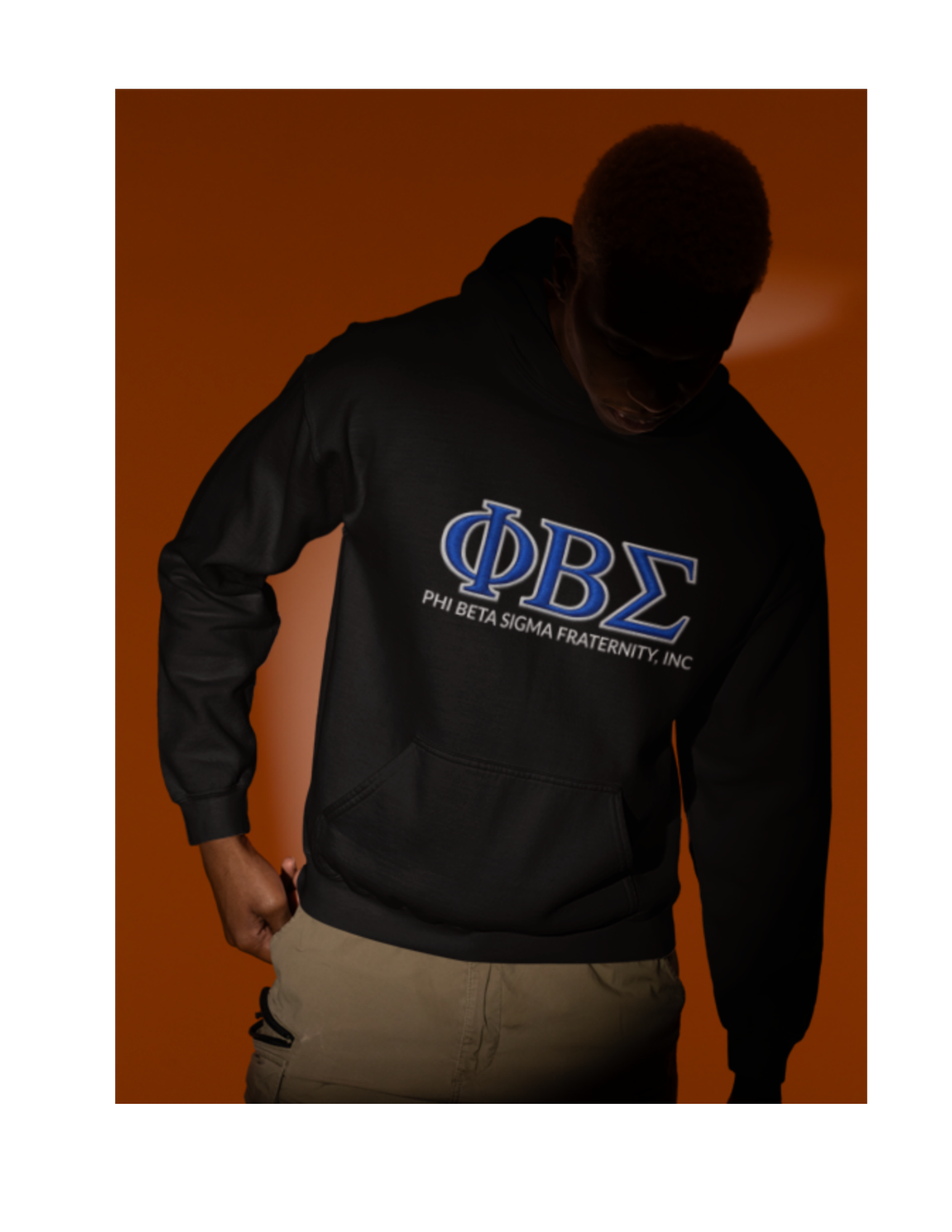 Model wearing black Phi Beta Sigma fraternity hoodie with blue ΦΒΣ Greek letters and Phi Beta Sigma Fraternity Inc text, Divine Nine Sigma fraternity apparel.