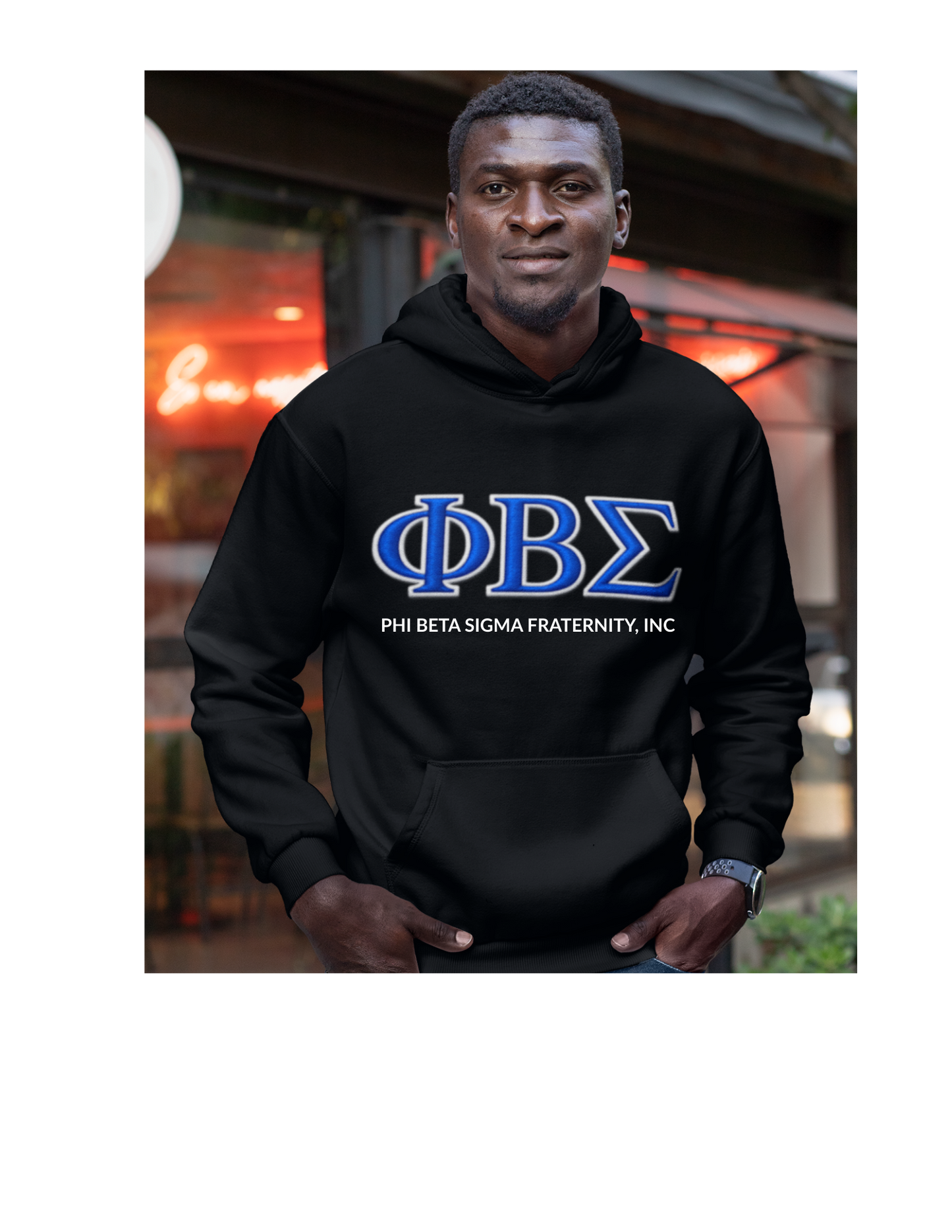 Model wearing black Phi Beta Sigma fraternity hoodie featuring blue ΦΒΣ Greek letters and fraternity text, Sigma Divine Nine apparel.